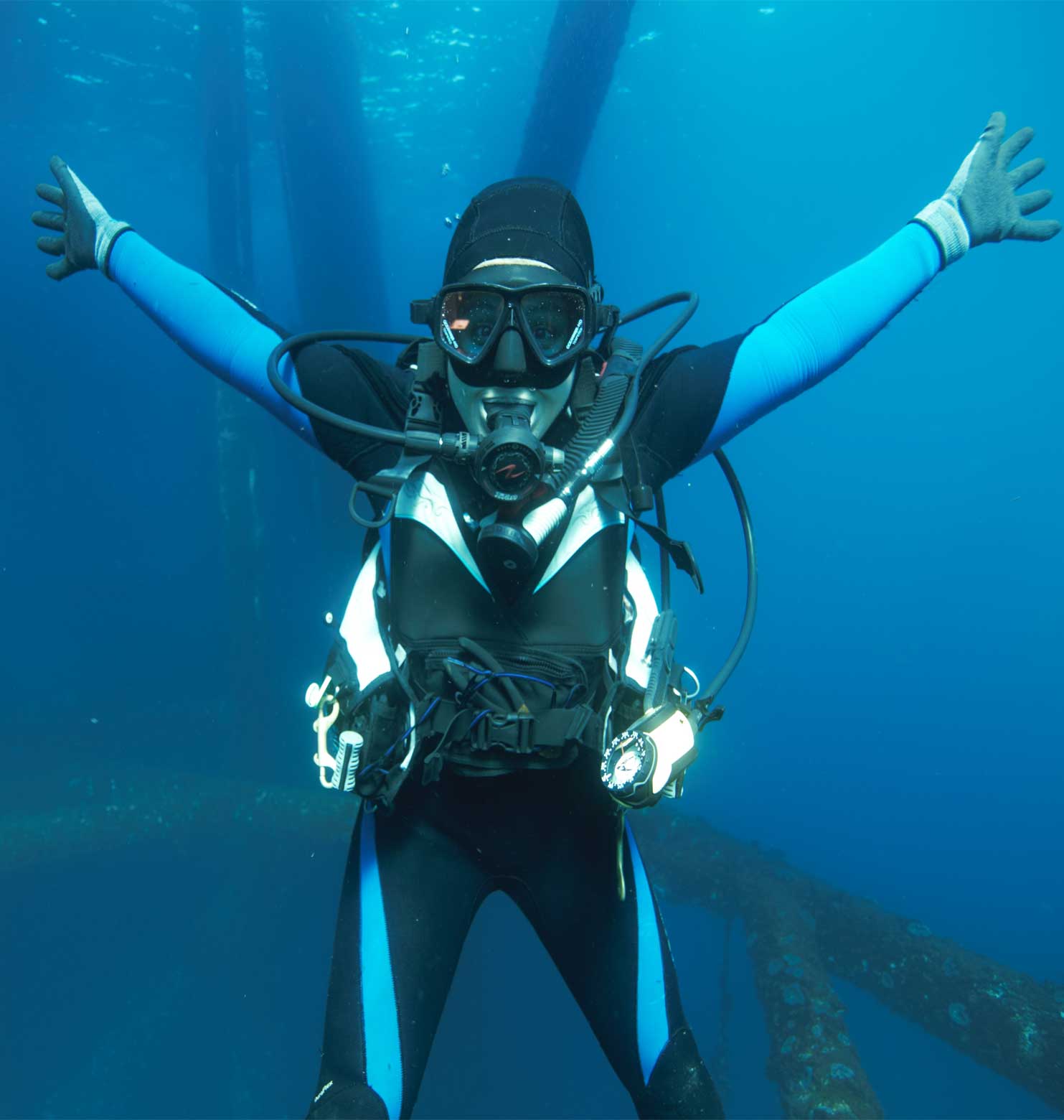 scuba diver in the water with out stretched arms