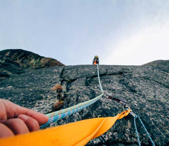 rope climbing steep cliff