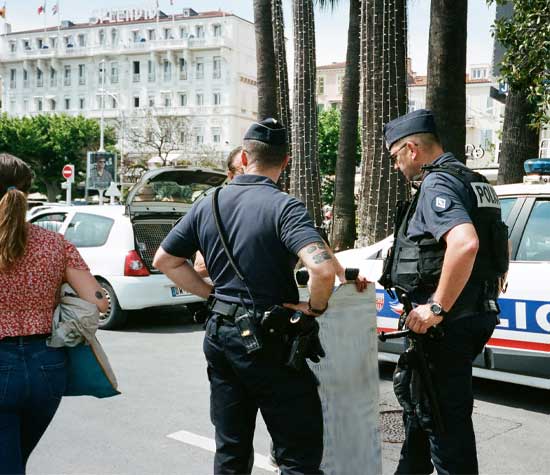 police officers talking to a man in a different country