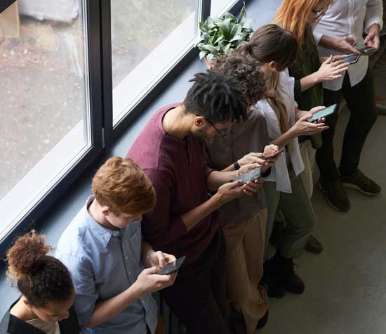 group of people looking at their phones
