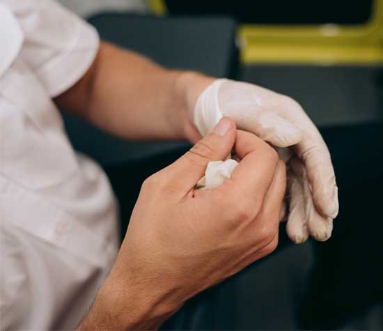 person putting on rubber gloves