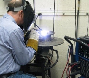 person wearing protective mask and gloves working in shop