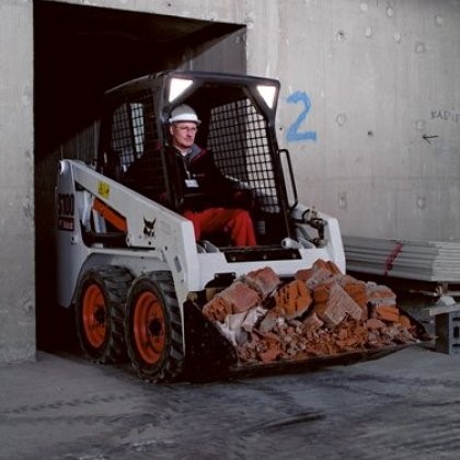 person driving skid steer loader/tractor
