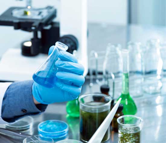 lab worker holding bottles