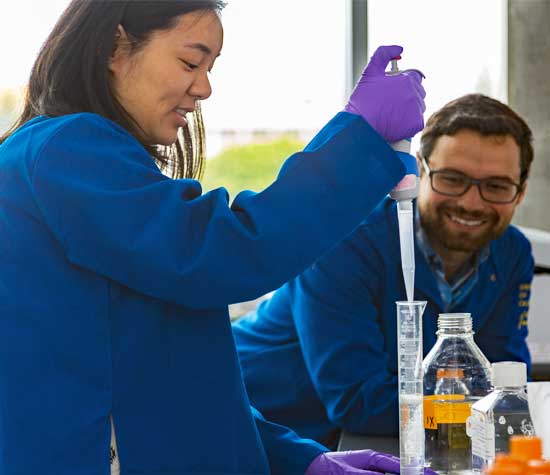 Two UCSB students wearing lab coats