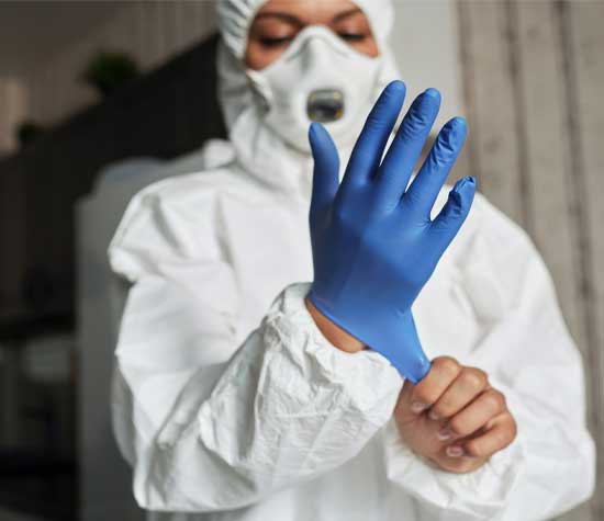 PPE lab worker on gloves
